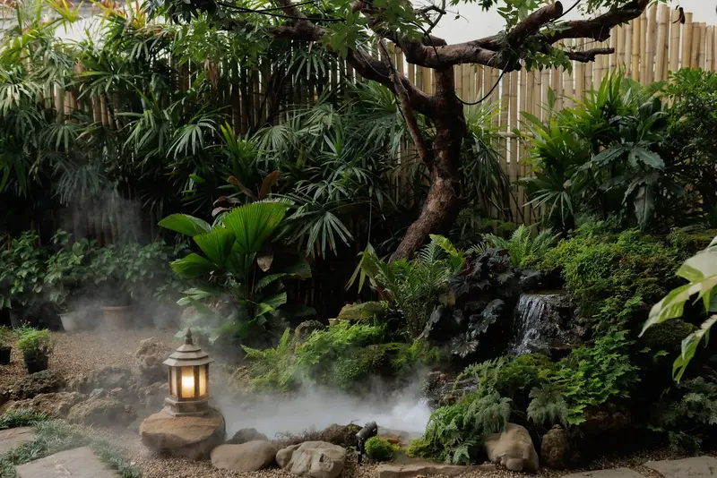 Garden with a stone lantern, mist and a small waterfall